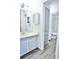 Updated bathroom featuring a modern vanity, cabinet, and convenient layout at 7185 S Gaylord St # A, Littleton, CO 80122