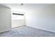 Serene bedroom with a large window and plush carpet, providing a comfortable retreat at 7185 S Gaylord St # A, Littleton, CO 80122