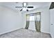 Bright bedroom with carpet, a ceiling fan, and patterned curtains at 7185 S Gaylord St # A, Littleton, CO 80122