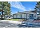 Exterior view of the clubhouse with manicured landscaping and plenty of parking at 7185 S Gaylord St # A, Littleton, CO 80122