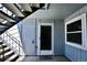 The entrance to this unit features a storm door, welcome mat, outdoor stairs, and a secure closet for storage at 7185 S Gaylord St # A, Littleton, CO 80122