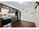 Kitchen area features stainless steel appliances, including a LG refrigerator, and updated hardware and countertops at 7185 S Gaylord St # A, Littleton, CO 80122