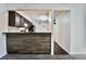Kitchen area with breakfast bar, granite countertops, stainless steel appliances, and access to the living area at 7185 S Gaylord St # A, Littleton, CO 80122