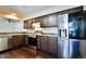 Updated kitchen boasts stainless steel appliances, granite countertops, updated cabinets, and hardwood flooring at 7185 S Gaylord St # A, Littleton, CO 80122