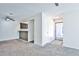 Open concept living room with neutral carpet, breakfast bar, ceiling fan, and view of the front door at 7185 S Gaylord St # A, Littleton, CO 80122