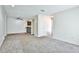 Open concept living room with neutral carpet, breakfast bar, ceiling fan, and an open floor plan at 7185 S Gaylord St # A, Littleton, CO 80122