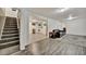 Finished basement with wood-look flooring, stairs, a sofa, rug and laundry area at 2279 S Lewiston St, Aurora, CO 80013