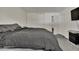 Bedroom with a queen bed, closet, light grey carpet, black and white stripped TV and white walls at 2279 S Lewiston St, Aurora, CO 80013