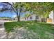 Quaint single-story home with lovely trees providing shade on a sunny, grassy front lawn at 2279 S Lewiston St, Aurora, CO 80013