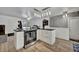 Well-lit kitchen with stainless steel appliances, wooden floor, and white cabinets and countertops at 2279 S Lewiston St, Aurora, CO 80013