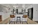 Modern kitchen with black countertops, white cabinets and a stylish breakfast bar at 2279 S Lewiston St, Aurora, CO 80013