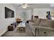 Comfortable living room features neutral colored walls, a ceiling fan and a large sectional sofa at 2279 S Lewiston St, Aurora, CO 80013