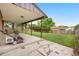 Spacious covered patio with a view of the well-manicured, green backyard at 13052 W Asbury Pl, Lakewood, CO 80228