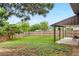 Sprawling backyard with lush green grass and mature trees and foliage at 13052 W Asbury Pl, Lakewood, CO 80228