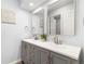 Bathroom boasts a modern dual sink vanity with two decorative mirrors and updated paint at 13052 W Asbury Pl, Lakewood, CO 80228