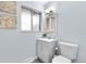 A well lit bathroom with grey vanity, modern mirror and lighting at 13052 W Asbury Pl, Lakewood, CO 80228