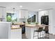 Bright kitchen featuring white cabinets, butcher block counters, and black appliances at 13052 W Asbury Pl, Lakewood, CO 80228