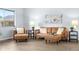 Comfortable living room with brown leather furniture and light wood flooring at 13052 W Asbury Pl, Lakewood, CO 80228