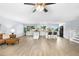 Spacious open-concept living space with kitchen island and wood floors offering a light-filled atmosphere at 13052 W Asbury Pl, Lakewood, CO 80228