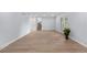 Open living space with light wood floors and access to other rooms at 13052 W Asbury Pl, Lakewood, CO 80228