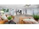Open-concept living area with white cabinets and a breakfast bar at 13052 W Asbury Pl, Lakewood, CO 80228