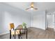 Home office features a ceiling fan, updated flooring, closet space and a small table with work space at 13052 W Asbury Pl, Lakewood, CO 80228