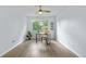 Bright home office features a ceiling fan, updated flooring and a large window overlooking a lush green yard at 13052 W Asbury Pl, Lakewood, CO 80228