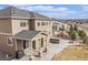 Back exterior showcasing a patio, hot tub, stone fireplace, and well-maintained backyard at 2627 Hillcroft Ln, Castle Rock, CO 80104