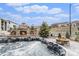 Backyard featuring a hot tub, stone fireplace, and fire pit for outdoor relaxation and entertainment at 2627 Hillcroft Ln, Castle Rock, CO 80104