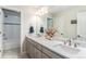 Bathroom featuring double sinks, granite counters, and tiled shower at 2627 Hillcroft Ln, Castle Rock, CO 80104