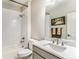 Bright bathroom with white herringbone tiled shower, white vanity, and modern fixtures at 2627 Hillcroft Ln, Castle Rock, CO 80104