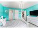 Stylish bedroom with a chandelier, turquoise walls, and modern decor at 2627 Hillcroft Ln, Castle Rock, CO 80104