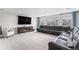 An expansive bonus room features large windows, comfortable seating, and entertainment center with TV at 2627 Hillcroft Ln, Castle Rock, CO 80104