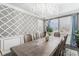 Luxurious dining area featuring a decorative wall, stunning chandelier, and views through shuttered windows at 2627 Hillcroft Ln, Castle Rock, CO 80104