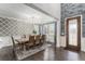 Bright dining room with elegant chandelier, patterned wallpaper, hardwood floors, and large windows at 2627 Hillcroft Ln, Castle Rock, CO 80104