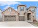 Attractive home exterior featuring stone accents, a three-car garage, and unique architectural details at 2627 Hillcroft Ln, Castle Rock, CO 80104