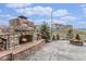 Stone fireplace with wood storage and a fire pit, creating a cozy outdoor gathering space at 2627 Hillcroft Ln, Castle Rock, CO 80104