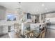 Bright kitchen area with island, glass table and chairs, offering modern living at 2627 Hillcroft Ln, Castle Rock, CO 80104
