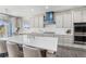 Gourmet kitchen features white cabinets, a large center island with seating, and stainless steel appliances at 2627 Hillcroft Ln, Castle Rock, CO 80104