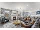 Bright living room with a fireplace, large sectional sofa, and an adjacent dining area at 2627 Hillcroft Ln, Castle Rock, CO 80104