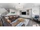 Elegant living room with hardwood floors, a decorative chandelier, and comfortable leather seating at 2627 Hillcroft Ln, Castle Rock, CO 80104