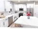 Modern kitchen with white cabinetry, stainless steel appliances, and marble countertop at 1606 W 166Th Ave, Broomfield, CO 80023
