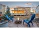 Inviting backyard featuring a stone fire pit, outdoor seating, and a spacious lawn perfect for entertaining at 19973 W 94Th Ln, Arvada, CO 80007