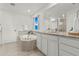 Serene bathroom featuring double sinks, granite countertops, a soaking tub, and a separate shower at 19973 W 94Th Ln, Arvada, CO 80007
