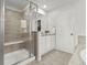 Clean and modern bathroom featuring a glass shower, tile flooring, and a vanity with ample storage at 19973 W 94Th Ln, Arvada, CO 80007