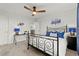 Cozy bedroom with white walls, a modern ceiling fan, and a wrought iron bed frame at 19973 W 94Th Ln, Arvada, CO 80007