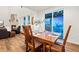 Dining area with seating for four, leading to a living room with a fireplace and large sliding glass doors at 19973 W 94Th Ln, Arvada, CO 80007