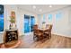 Cozy dining area with wood table, wine storage barrel, and sliding glass doors to the outdoor deck at 19973 W 94Th Ln, Arvada, CO 80007