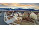 Stunning two-story home featuring solar panels and mountain views at sunset at 19973 W 94Th Ln, Arvada, CO 80007