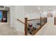 Hallway with iron railing overlooking the dining area and a view of the adjacent living spaces at 19973 W 94Th Ln, Arvada, CO 80007